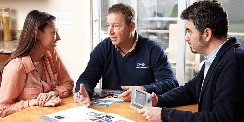 Technician explains to homeowners what a zoning system is and shows them how it works.