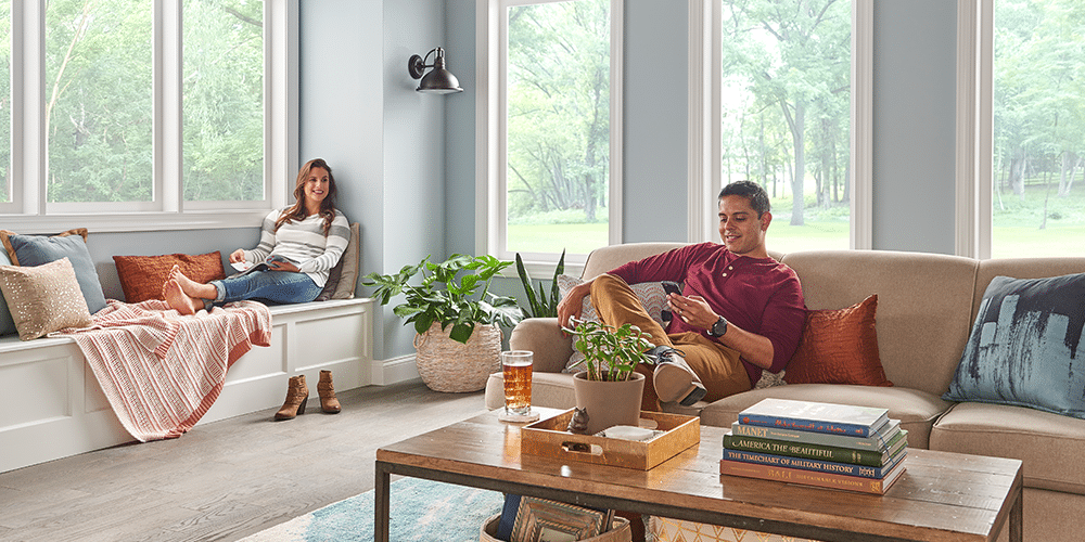 Young couple relaxes in living room with ideal winter indoor air quality.