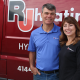 Owners Julius and Erin, creators of the Comfort First Membership program, stand by red RJ truck.