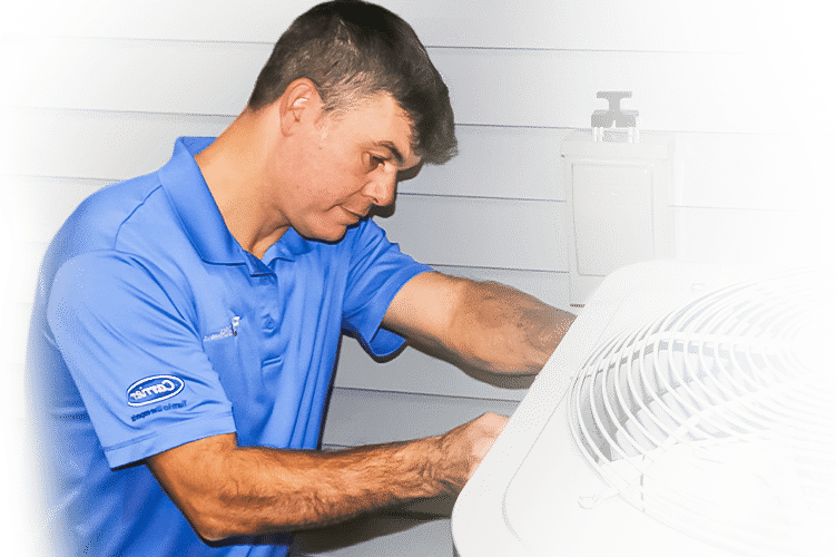 RJ owner Julius kneels in front of A/C unit to perform a routine clean and check.